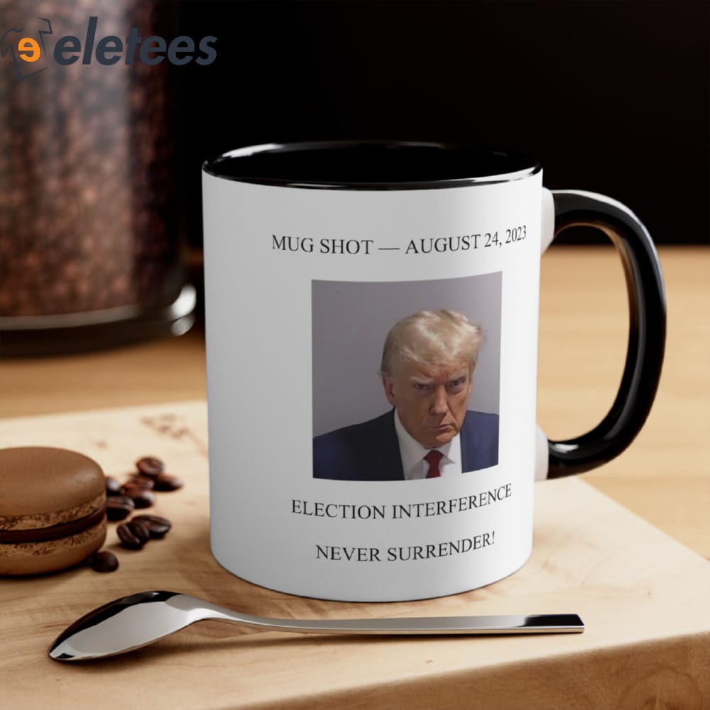 https://eletees.com/wp-content/uploads/2023/08/Trump-Mugshot-August-24-2023-Election-Interference-Never-Surrender-Mug-1.jpg